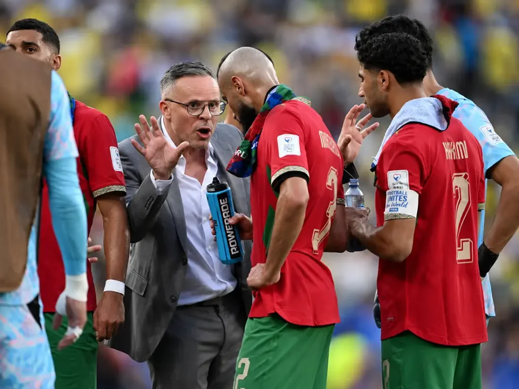 Morocco coach giving tactical instructions to Atlas Lions players during World Cup 2026 match